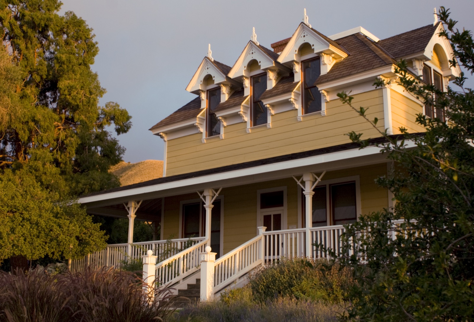 The yellow historic ranch house and covered porch at Gilman Ranch in Banning.